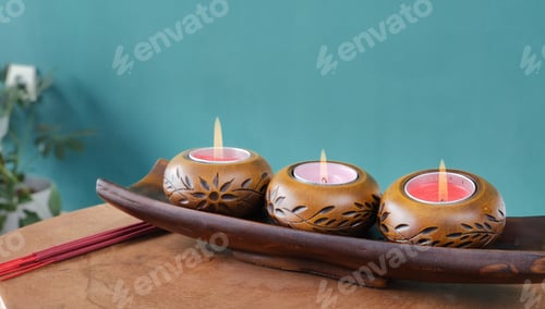 Preview: lit candles with beautiful eastern ornament on light table