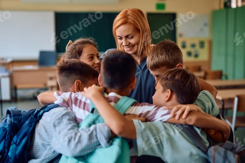 Preview: Group of happy school kids and their teacher greeting in the classroom.