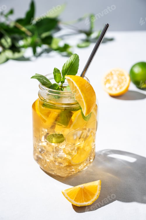Preview: Lemonade drink or cold tea with fresh lemon, mint and ice in a jar. Refreshing citrus cocktail
