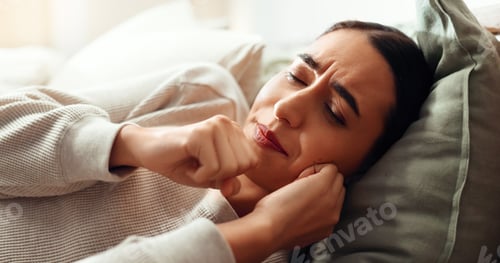 Preview: Woman, coughing and sick in home, cold influenza and laying on bed with bacteria infection. Female