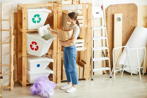 Preview: Woman sorting waste in bins