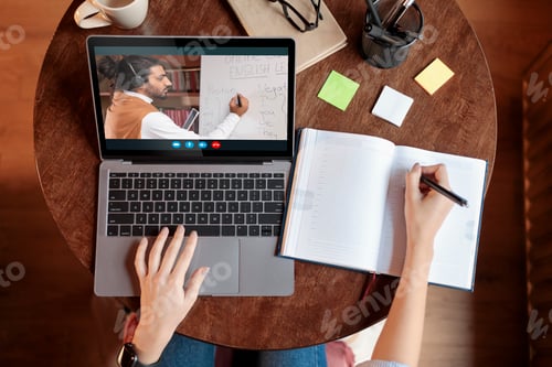 Preview: Top view of female student attending online training