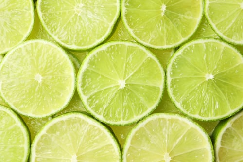 Preview: Fresh juicy lime slices as background, top view