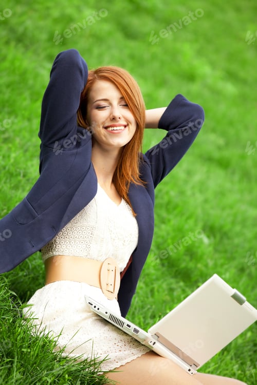Preview: Redhead girl at green grass with notebook