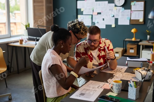 Preview: Multiethnic Young Adults Collaborating on Project in Modern Office Setting