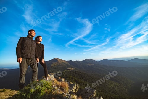 Preview: The smiling couple standing on the beautiful mountain landscape background