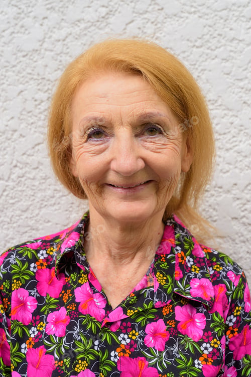 Preview: Face of a senior woman smiling outdoors during summer