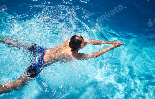 Preview: Overhead view of young man swimming in swimming pool
