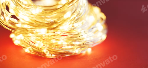 Preview: christmas beautifull shiny gold garland on a red background. sparkle festive background. banner