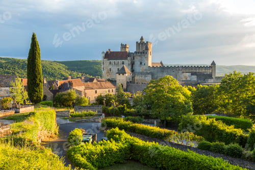 Preview: Landscape with trees, hedges and medieval castle with graveyard in the mid distance.