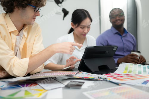 Preview: Multiethnic team of architects and designers are meeting to brainstorm design an application