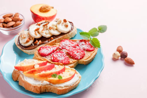 Preview: Healthy sweet sandwiches with fruits and berries on pink colorful background.