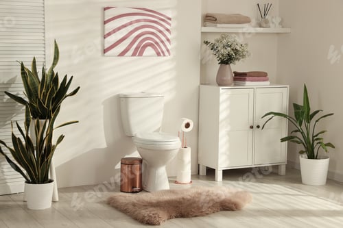 Preview: Ceramic toilet bowl, houseplants and necessities in restroom