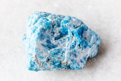Preview: sample of rough apatite rock on white marble