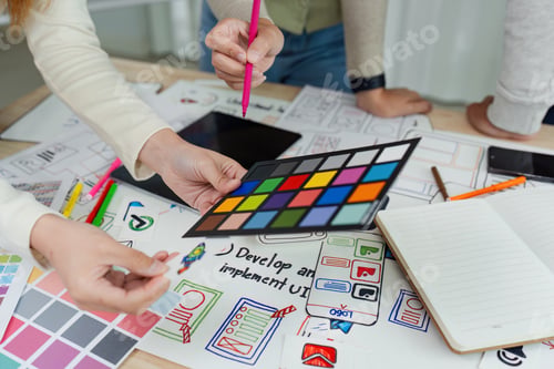 Preview: team of UI UX web designer are working together to develop mobile responsive websites with UI UX
