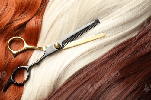 Preview: Strands of different beautiful hair and hairdresser's scissors, top view
