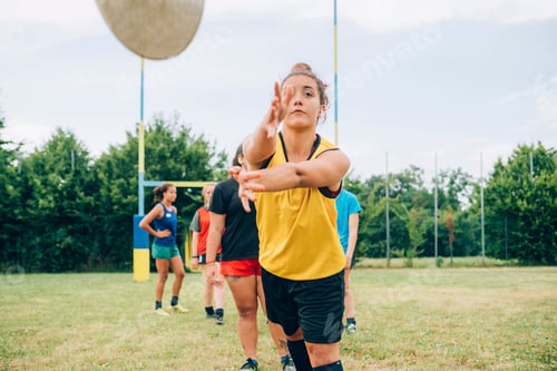Preview: Focused athlete playing volleyball outdoors