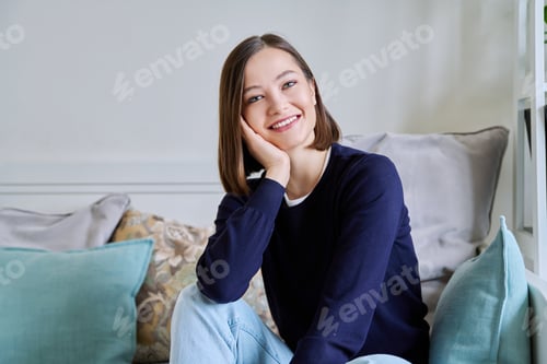 Preview: Smiling Woman Relaxing on Sofa at Home