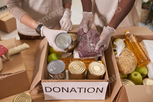 Preview: Unrecognizable Volunteers Packing Food