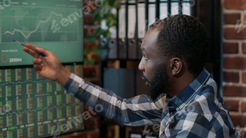 Preview: Male financial analyst looking at forex trade market numbers