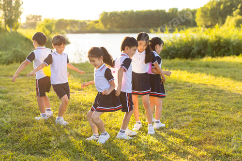 Preview: Cheerful Chinese school children playing in park