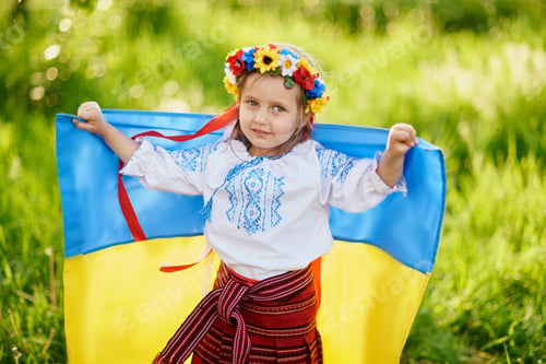 Preview: Ukrainian child girl in embroidered shirt vyshyvanka with yellow and blue flag of Ukraine in field.
