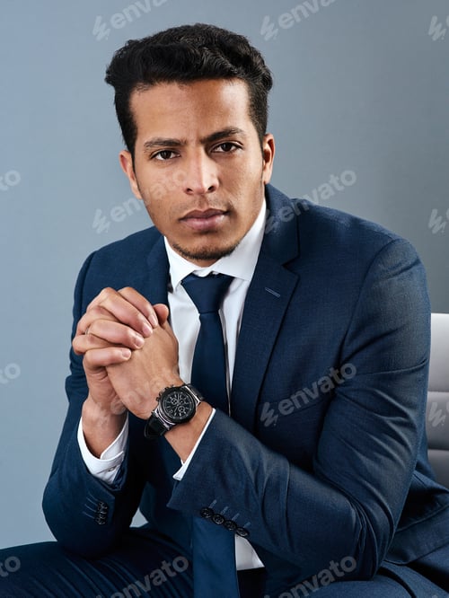 Preview: Its just business to him. Studio shot of a corporate businessman posing against a grey background.