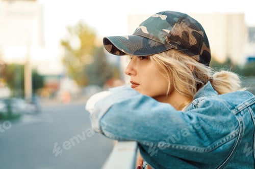 Preview: Casual dreamy girl watching the city from a higher point