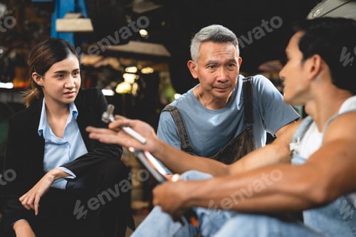Preview: Asian woman customer talking with professional mechanic worker or workshop owner, client checking