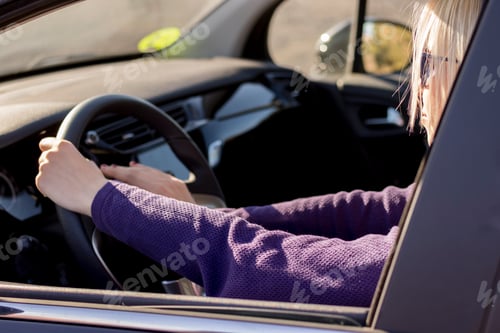Preview: Closeup hands of woman,hand pushing on steering wheel honking horn