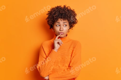 Preview: Portrait of unhappy thoughtful dark skinned melancholy young woman feels upset looks aside with disp