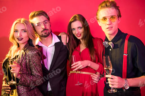 Preview: two glamorous stylish couples drinking champagne and having fun together