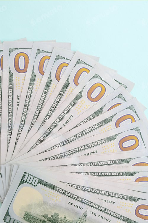 Preview: Arrangement of Hundred Dollar Bills on Light Blue Surface