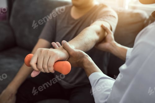 Preview: physiotherapist helping a patient lifting dumbbells work through his recovery