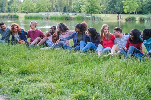 Preview: Group of friends of different origins having a good lifestyle time in the park outdoors