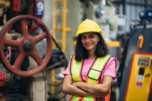 Preview: Portrait of industrial worker inspecting and check up machine at factory machines.