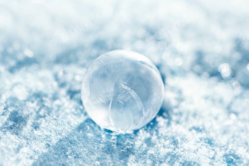 Preview: frozen bubble with bokeh background. Beautiful frosty patterns on frozen soap bubble