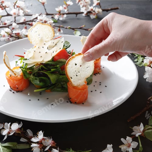 Preview: Eating restaurant dish on white plate on black background, closeup
