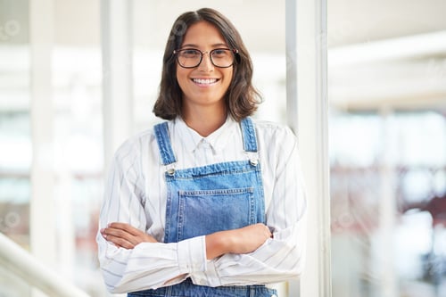 Preview: Portrait of a confident young businesswoman working in a modern office