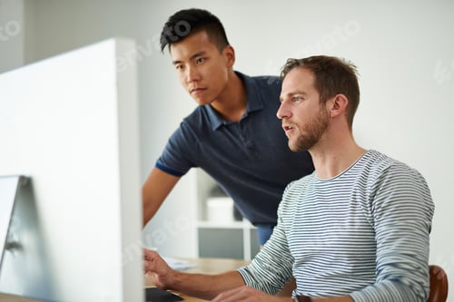 Preview: Cropped shot of two designers working together on a project in an office