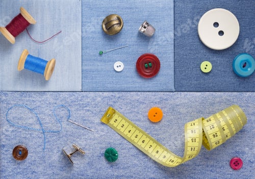 Preview: sewing tools and accessories on jeans background