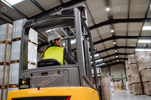 Preview: Female warehouse worker driving forklift. Warehouse worker preparing products for shipmennt