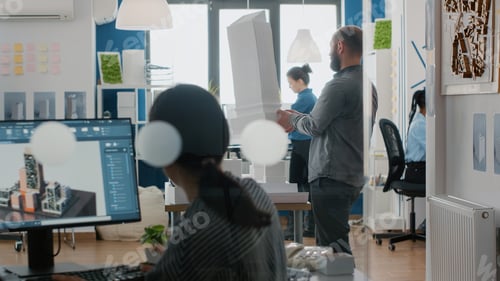 Preview: Architect analyzing building model and maquette in architectural office