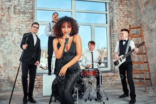 Preview: Repetition of multi ethnic jazz band in loft. Bass guitar player, electric guitar player