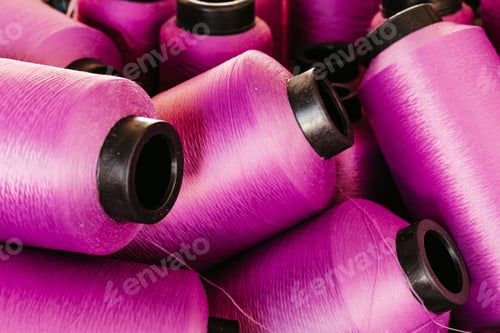Preview: many pink threads are laid out and ready for sale on a pile