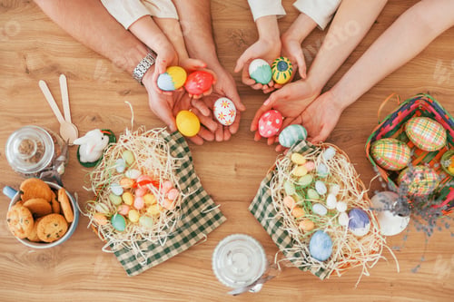 Preview: Top view of hands on the table. Happy family celebrating Easter holidays together