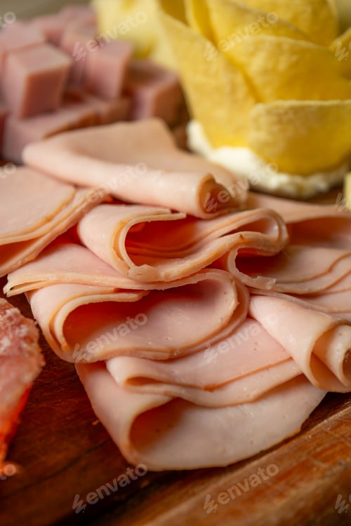 Preview: a platter with meat and cheeses, some cheese, and lemon