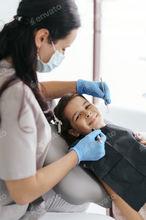 Preview: Little beautiful girl at the dentist looking at the camera and smiling