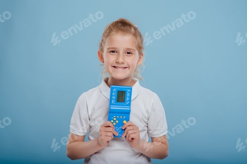 Preview: little girl with blue tetris game in child hand, isolated on white background,