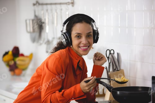 Preview: African American woman happy and fun to cooking healthy food in home kitchen, online cook learning